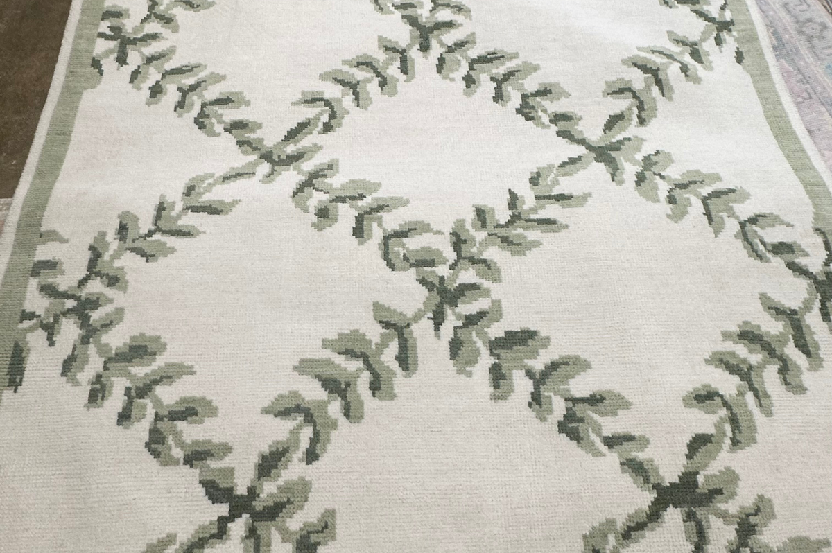 Rug with green leaf pattern on a white background