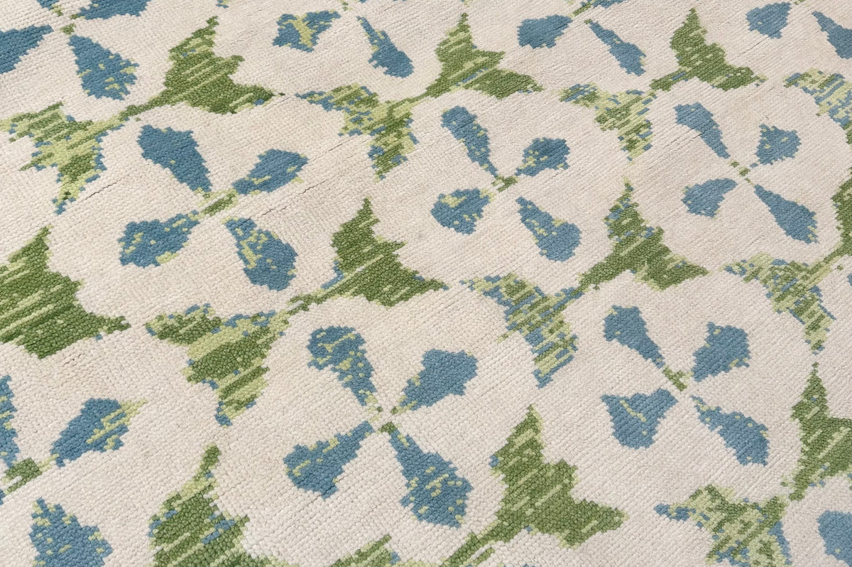 Patterned oushak hand-knotted with blue and green design on a beige background