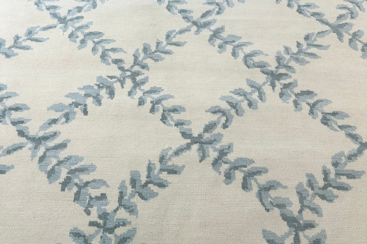 Rug with blue leaf pattern on a beige background